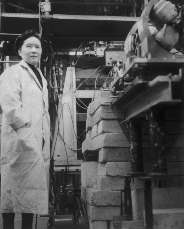 Original Caption: Dr. Chien-Shiung Wu, professor of Physics at Columbia University in New York, is shown at work with the apparatus used in experimental work that reportedly has conclusively proved a new and fundamental theory in nuclear physics---the theory of conservation of vector current. Cited as one of the world's foremost experimental physicists, Professor Wu and two associates tested the theory in a lengthy series of experiments. The theory deals with a type of subatomic behavior known as "weak interaction," one of nature's four basic kinds of physical interaction.